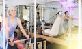 Mature woman practicing pilates stretching exercises on reformer at gym Royalty Free Stock Photo