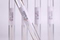 Positive medical test tube sample for Coronavirus with label Covid-19 with other blury tubes in background