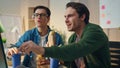 Positive men looking monitor eating sandwiches at office closeup. Lunch break Royalty Free Stock Photo