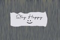 Positive message on blue wall with happy smile sign- Stay happy. Happiness concept. Note to self. Healing morning inspirational