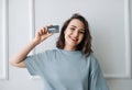 Positive Middle-Aged Woman Showing Credit Card in Close-up Studio Shot. Happy Middle-Aged Lady Presenting Credit Card