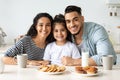 Positive middle-eastern family having breakfast together at kitchen Royalty Free Stock Photo