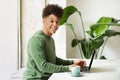 Positive millennial african american man IT employee working at cafe Royalty Free Stock Photo