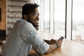 Stylish young black guy enjoy weekend at home with smartphone