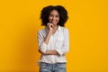 Positive Millennial Black Girl Touching Chin And Posing At Camera