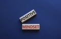 Positive Mindset symbol. Concept words Positive Mindset on wooden blocks. Beautiful deep blue background. Business and Positive