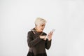 A positive modern elderly woman holds a tablet in her hands and uses it. The older generation and modern technology. Royalty Free Stock Photo