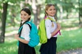 Positive mood. teenage girls with backpacks walking in park. Back to school. Teen kids with backpack. concept of