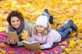 Positive mother and daughter reading books