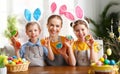 Positive mother and kids with Easter cookies at home Royalty Free Stock Photo