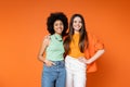 Positive and multiethnic girlfriends with bold Royalty Free Stock Photo