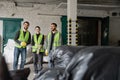 Positive multiethnic workers in fluorescent vests
