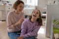 Positive mum and teen daughter playing with rat at home Royalty Free Stock Photo