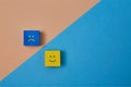 Positive and negative emotions. Positivity and negativity of thinking. Smiling and sad emoji on colorful wooden cubes