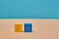 Positive and negative thinking, attitude. Positivity, negativity. Duality principle. Smile, sad emoji on wooden cubes