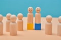 Positive and negative thinking. Emotions of people. Wooden people miniatures with smile, sad and unemotional emoji