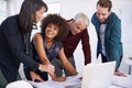 Positive about the new project. a group of architects using a laptop to work on their designs. Royalty Free Stock Photo