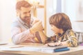 Positive nice father and son doing arm wrestling Royalty Free Stock Photo