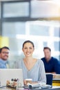 Positive office vibes. Portrait of a group of people working at their computers in an office. Royalty Free Stock Photo