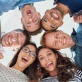 Positive about our performance. Low angle shot of excited people putting their heads together. Royalty Free Stock Photo