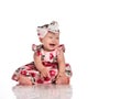 Positive overjoyed baby girl in festive dress shot