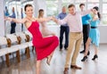 Positive pairs practicing vigorous jive movements in dance class