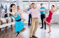 Positive pairs practicing vigorous jive movements in dance class