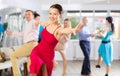 Positive pairs practicing vigorous jive movements in dance class