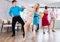 Positive pairs practicing vigorous jive movements in dance class