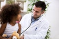 Positive pediatrician doctor examining kid Royalty Free Stock Photo