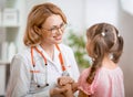 Positive pediatrician doctor examining kid Royalty Free Stock Photo