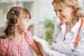 Positive pediatrician doctor vaccinating or