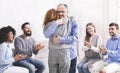 Positive people hugging during group rehab therapy