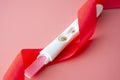 Positive platic pregnancy test isolated on pink background