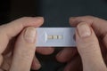 A positive pregnancy test in the hands of a woman.Portable pregnancy test