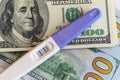 A positive pregnancy test on the US dollars background