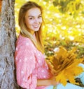 Positive pretty girl having fun in autumn park