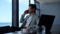 Positive professional talking smartphone at sea view workplace. Director call Royalty Free Stock Photo