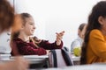 Positive pupil sitting near apple, book