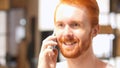 Positive Red Hair Beard Man talking on smart phone Royalty Free Stock Photo