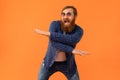 Positive redhaired man with beard dancing making funny moves, studio Royalty Free Stock Photo