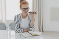 Positive redhead woman uses cellphone audio recognition to send message Royalty Free Stock Photo