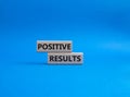 Positive results symbol. Concept words Positive results on wooden blocks. Beautiful blue background. Business and Positive Royalty Free Stock Photo