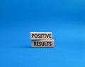 Positive results symbol. Concept words Positive results on wooden blocks. Beautiful blue background. Business and Positive Royalty Free Stock Photo