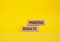 Positive results symbol. Concept words Positive results on wooden blocks. Beautiful yellow background. Business and Positive Royalty Free Stock Photo