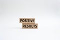 Positive results symbol. Concept words Positive results on wooden blocks. Beautiful white background. Business and Positive Royalty Free Stock Photo