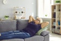 Positive retired mature aged woman grandmother lying and relaxing on sofa