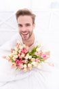 positive romantic man with march tulips. romantic man with march tulips flowers.