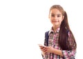 Positive schoolgirl looking in camera while holding smartphone