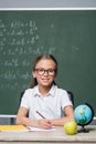 positive schoolgirl with pen smiling at Royalty Free Stock Photo